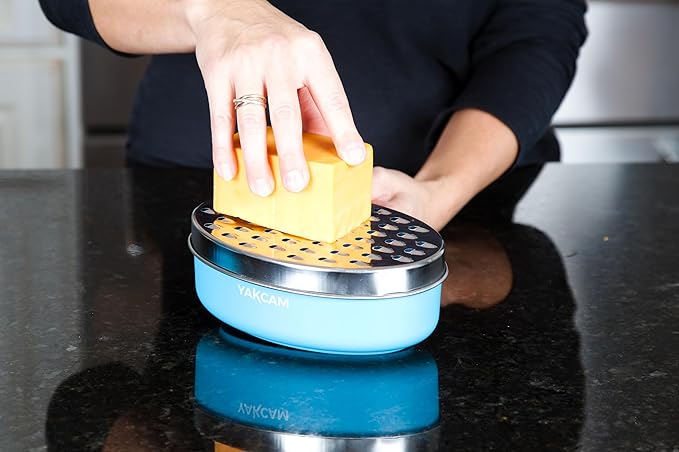 YAKCAM Cheese Grater with Container Bowl, 4-Pc Shredder and Zester | Fine and Course Stainless Steel Blades | Nonslip Base | Vegetable and Citrus Zester | 7x4.75x2.75 in